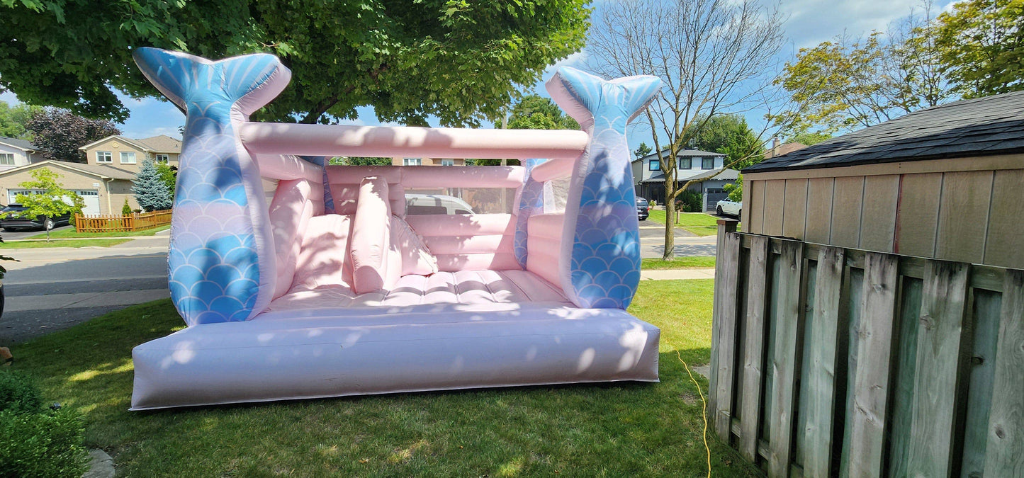 Colorful 14ft Mermaid Castle bounce house by Aura Luxury Rental Ltd with vibrant sea-themed design and playful mermaid decorations.