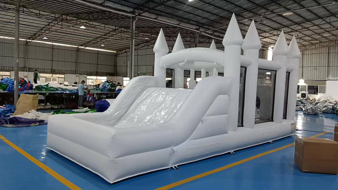 Colorful obstacle course with a ball pit and waterslide for kids, featuring bright, inflatable play structures by Aura Luxury Rental Ltd.