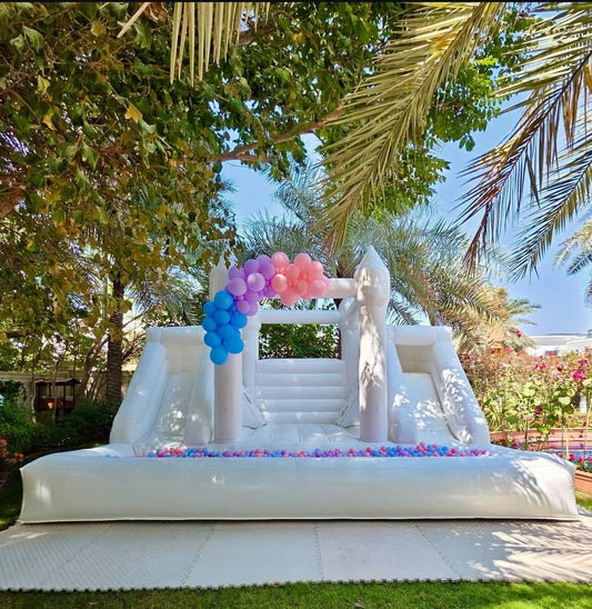 White double slide bouncy castle with ballpit for kids, featuring colorful slides and soft bouncing area, ideal for outdoor play.