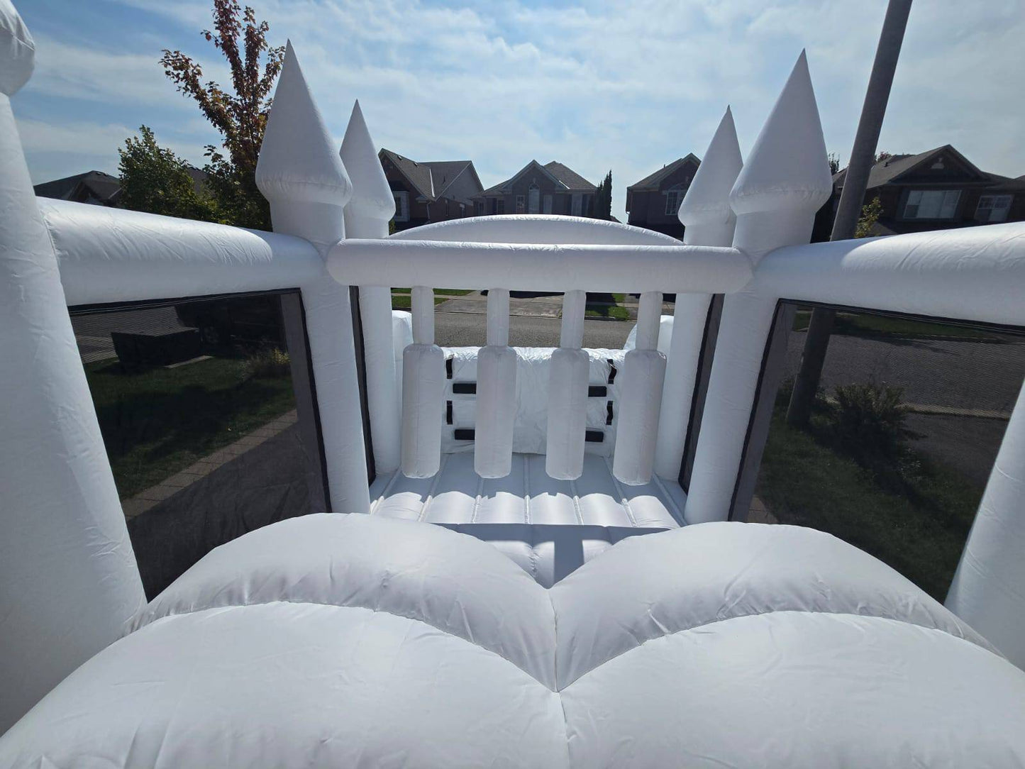 Colorful obstacle course with ball pit and waterslide, designed for kids' outdoor play, by Aura Luxury Rental Ltd.