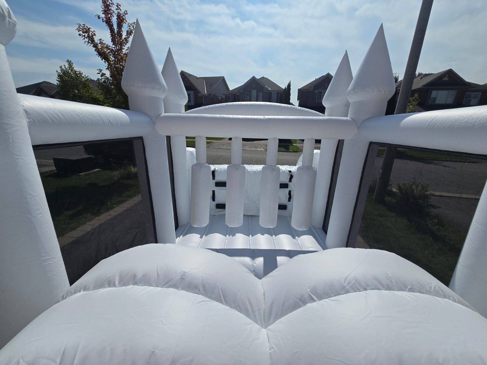Colorful obstacle course with ball pit and waterslide, designed for kids' outdoor play, by Aura Luxury Rental Ltd.