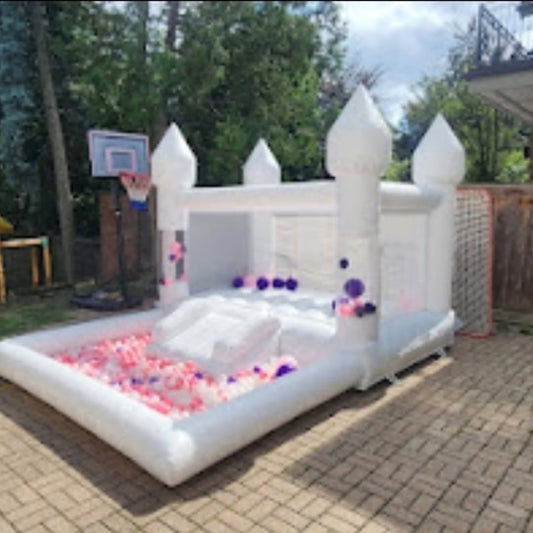 Mini bouncy castle with slide and ballpit by Aura Luxury Rental Ltd, showing colorful inflatable play structure with slide and ballpit area.