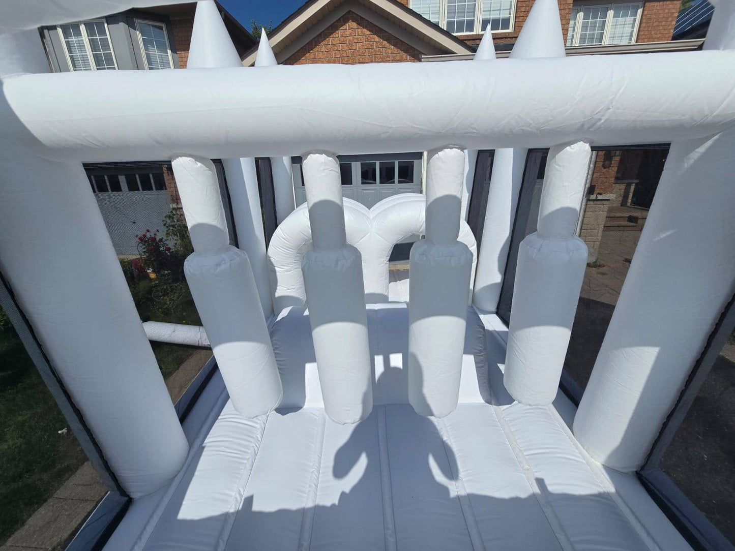 Aura Luxury Rental Ltd obstacle course with ball pit and waterslide, featuring colorful inflatable play areas and safety padding.