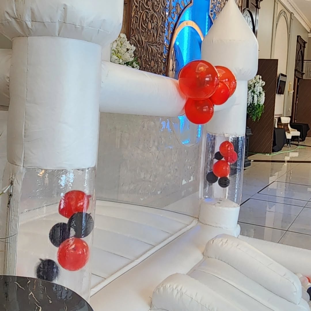 Mini bouncy castle with slide and ballpit from Aura Luxury Rental Ltd, colorful inflatable play structure for kids.