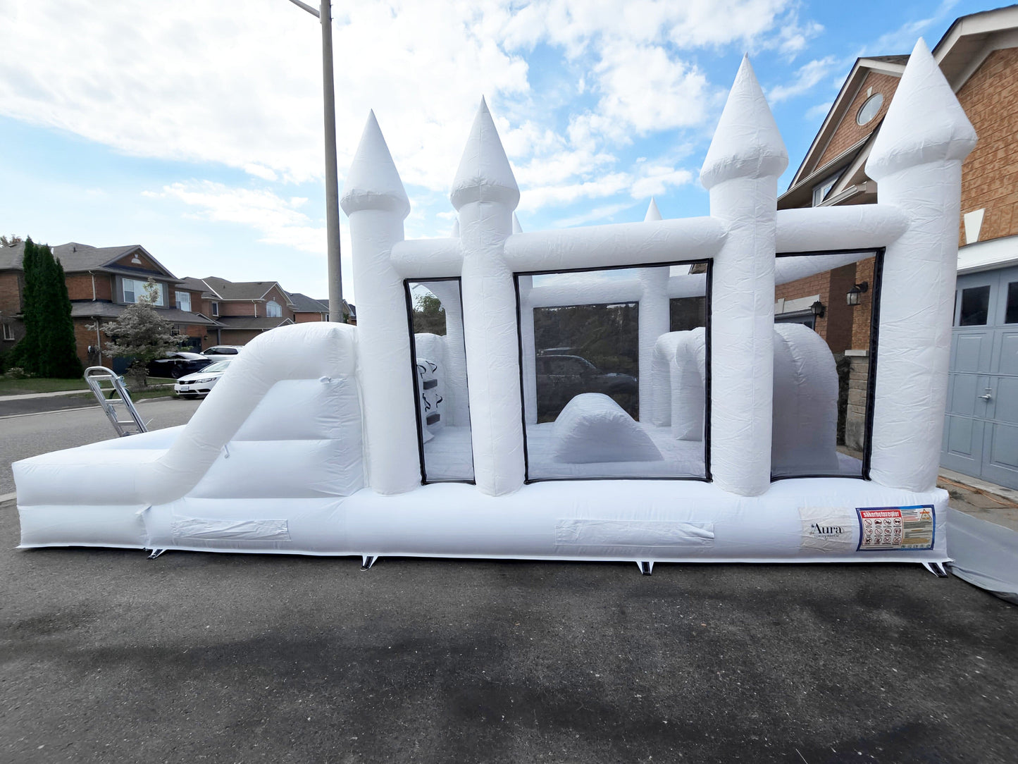 Colorful obstacle course with ball pit and waterslide from Aura Luxury Rental Ltd, designed for kids' outdoor play and active fun.