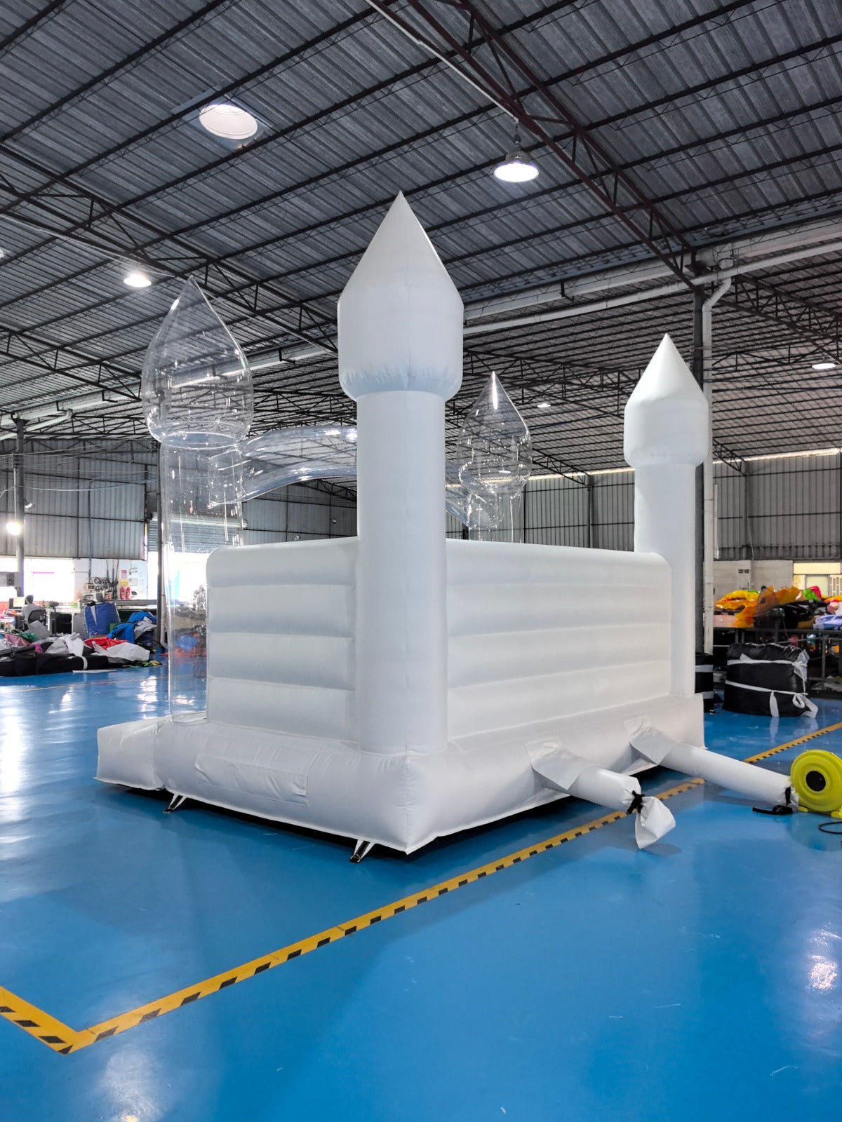 Colorful balloon pillar bounce house by Aura Luxury Rental Ltd with vibrant balloons and spacious jumping area for kids.